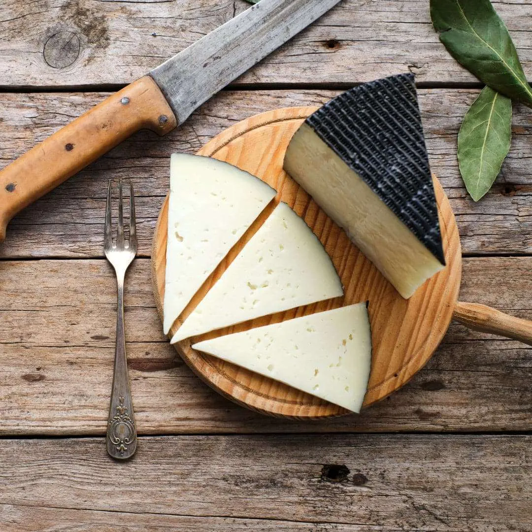 A wedge of aged Manchego with crackers